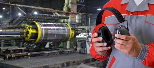 Worker holding hearing protection