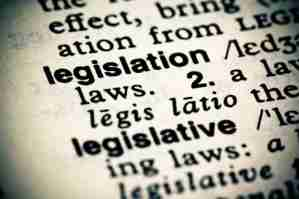 Close-up of a dictionary page highlighting the word 'legislation' and its definition.